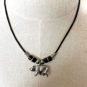 Silver tone bear pendant necklace on black cord